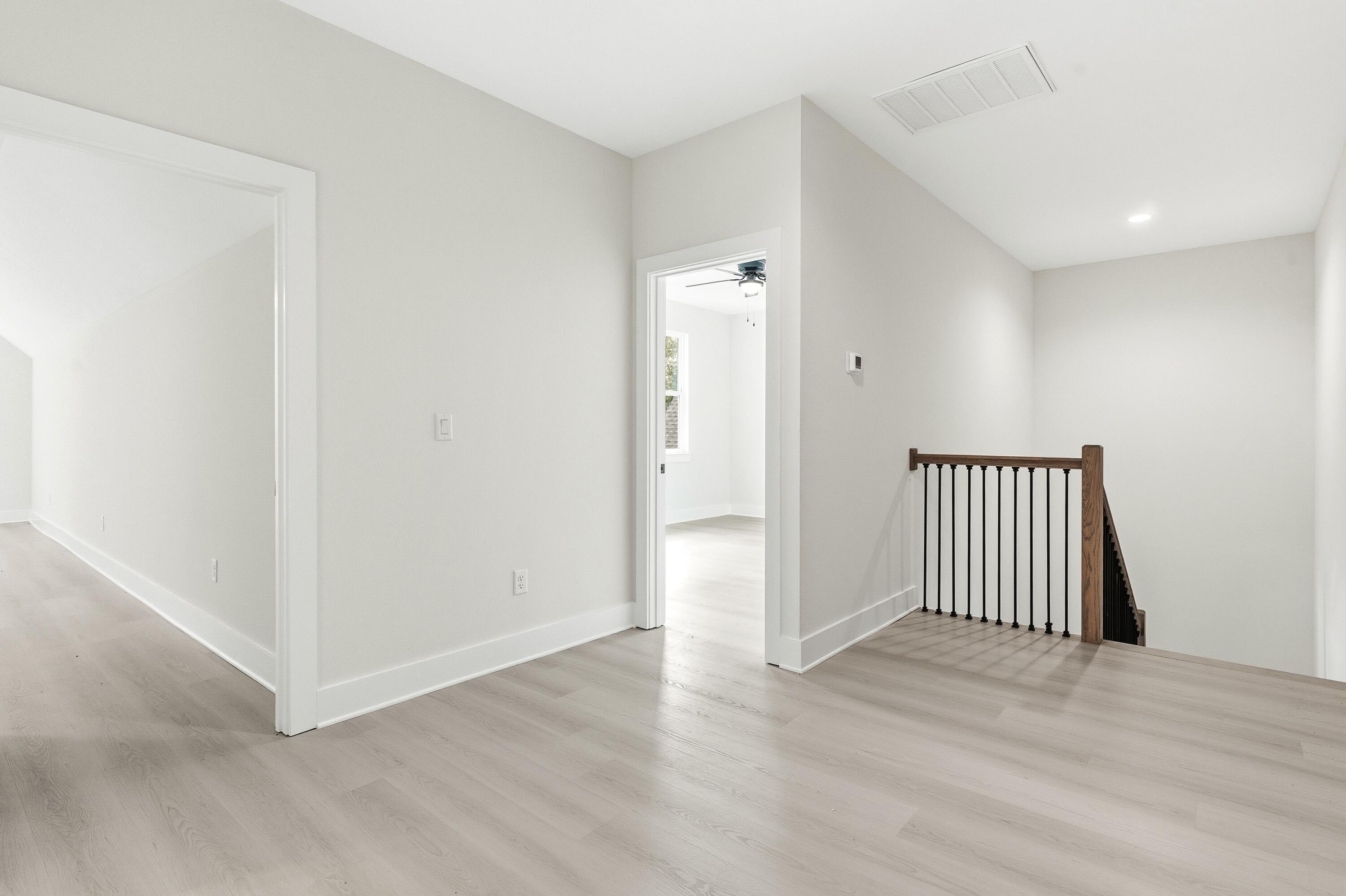 151 Redfish Pt Drive Freeport, FL 32439 - Photo 22 of 40 an empty room with wooden floor and windows