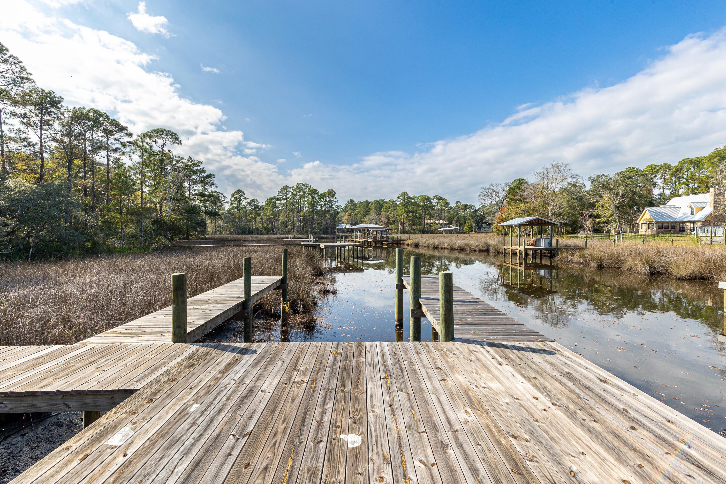 151 Redfish Pt Drive Freeport, FL 32439 - Photo 28 of 40 a view of a lake with tables and chairs