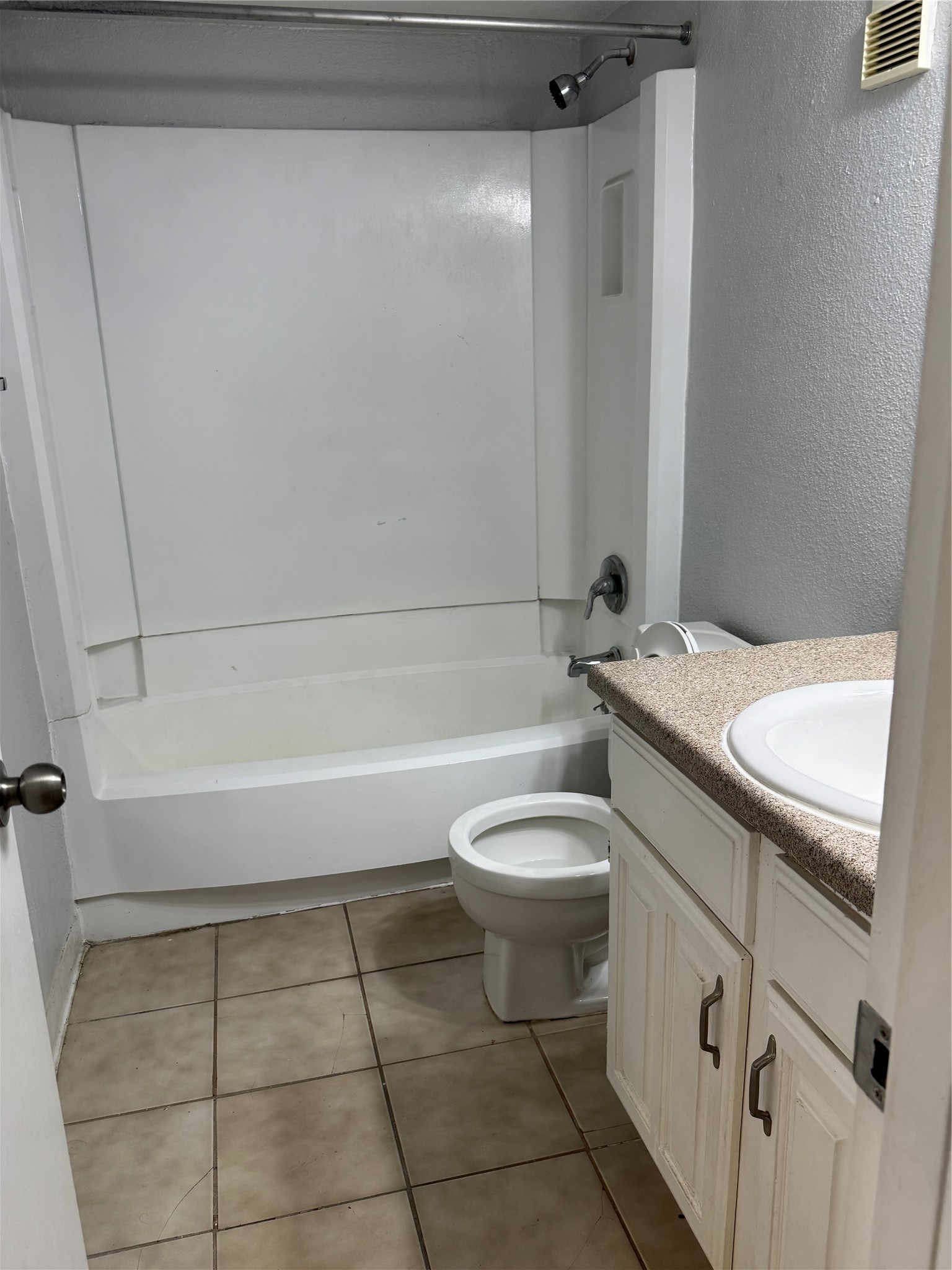 4747 Allendale Road, Unit 38 Houston, TX 77017 - Photo 7 of 15 a bathroom with a granite countertop toilet a sink and bathtub