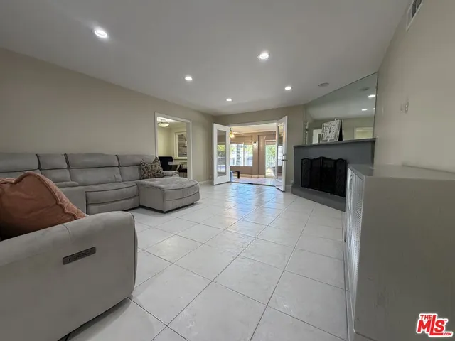 a living room with couches and kitchen view