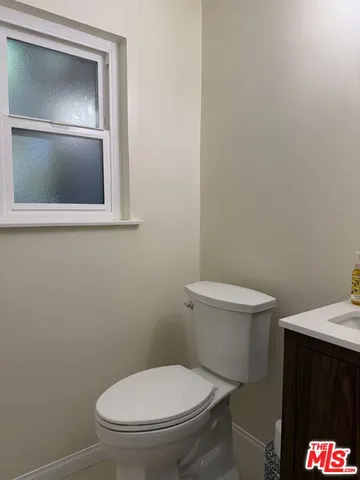 a white toilet sitting next to a bathroom sink