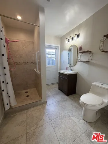 a bathroom with a sink toilet and mirror
