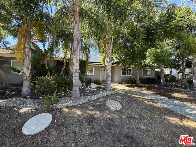 a view of a chairs and table in the backyard