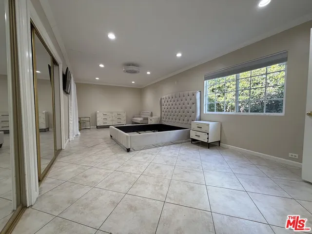 a view of an empty room and a bathroom