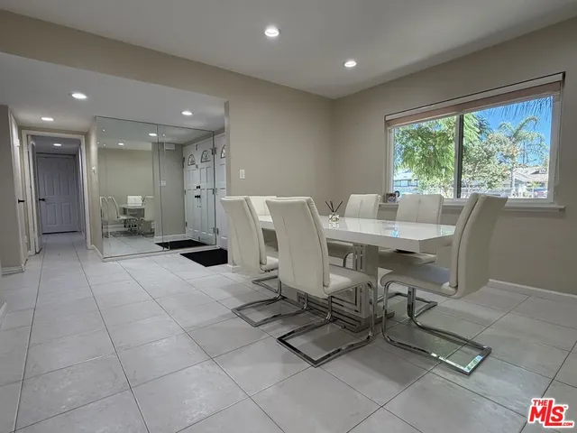 a view of a dining room with furniture and a floor to ceiling window
