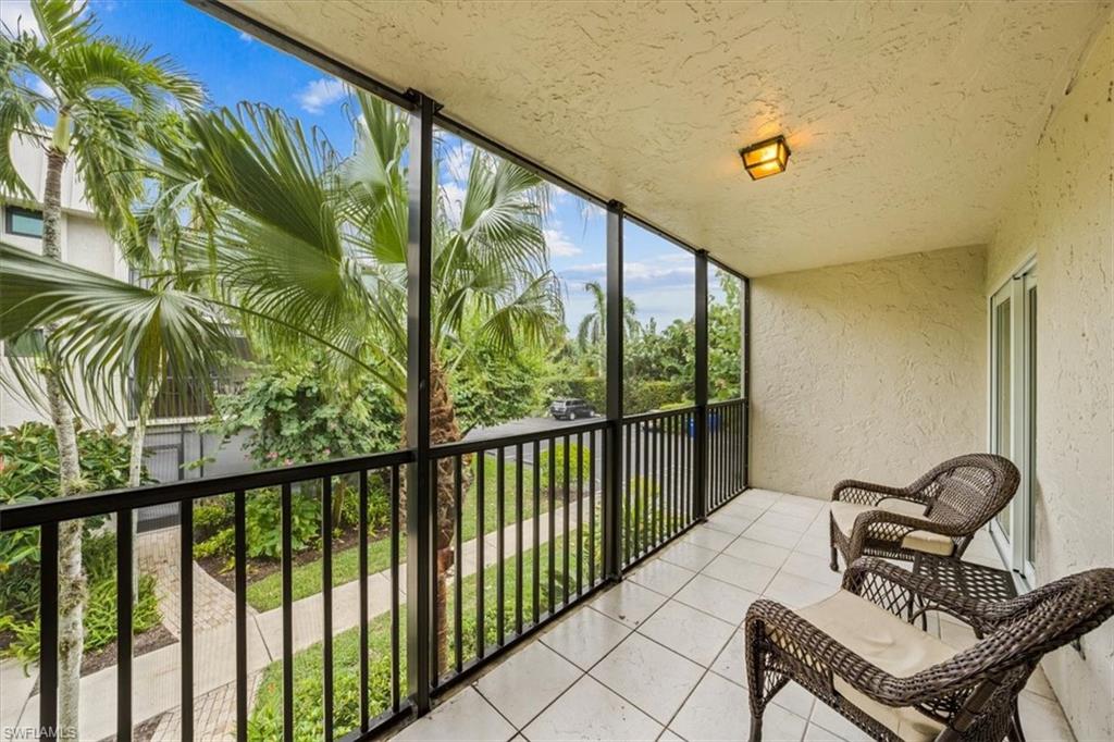 788 Park Shore Drive, Unit E20 Naples, FL 34103 - Photo 11 of 37 a view of a balcony with chairs
