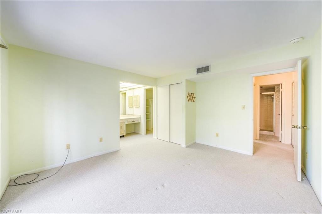 788 Park Shore Drive, Unit E20 Naples, FL 34103 - Photo 16 of 37 an empty room with windows