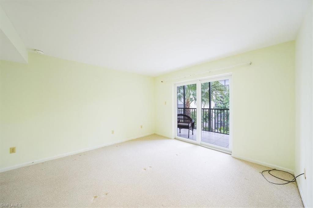 788 Park Shore Drive, Unit E20 Naples, FL 34103 - Photo 17 of 37 an empty room with windows