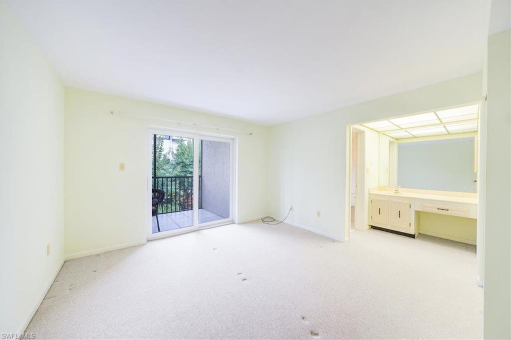 788 Park Shore Drive, Unit E20 Naples, FL 34103 - Photo 18 of 37 a view of an empty room with a window
