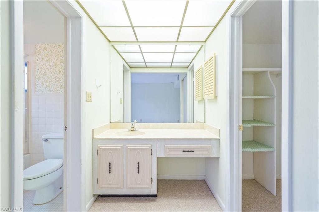 788 Park Shore Drive, Unit E20 Naples, FL 34103 - Photo 19 of 37 a bathroom with a sink toilet and a mirror