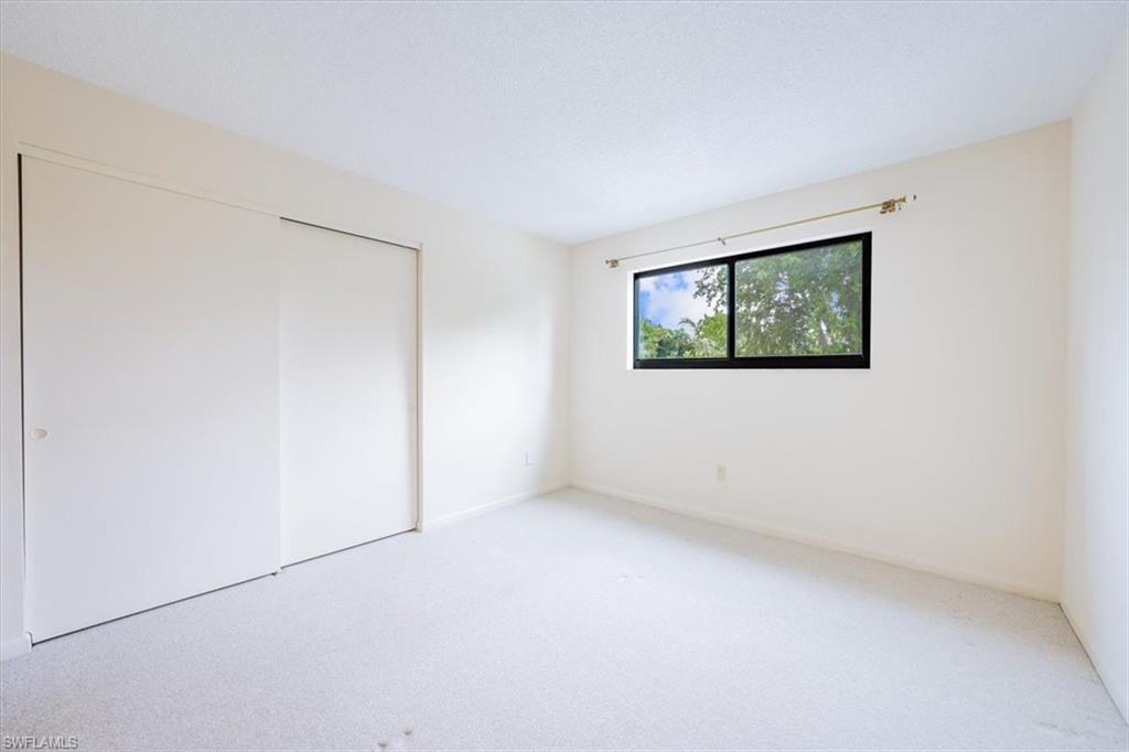 788 Park Shore Drive, Unit E20 Naples, FL 34103 - Photo 22 of 37 an empty room with windows