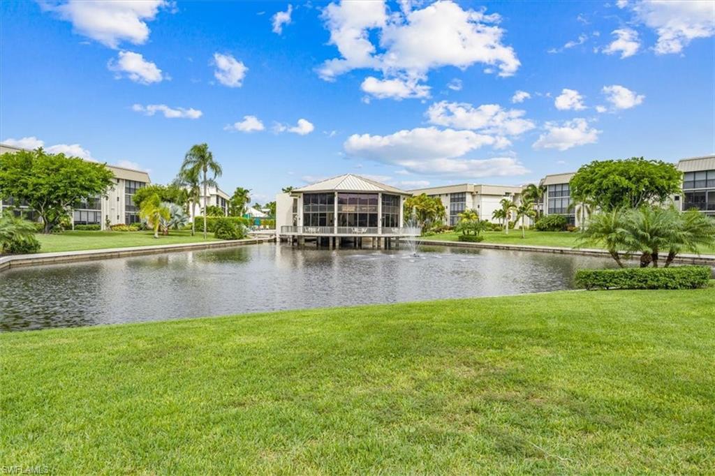 788 Park Shore Drive, Unit E20 Naples, FL 34103 - Photo 26 of 37 a view of a lake with a yard
