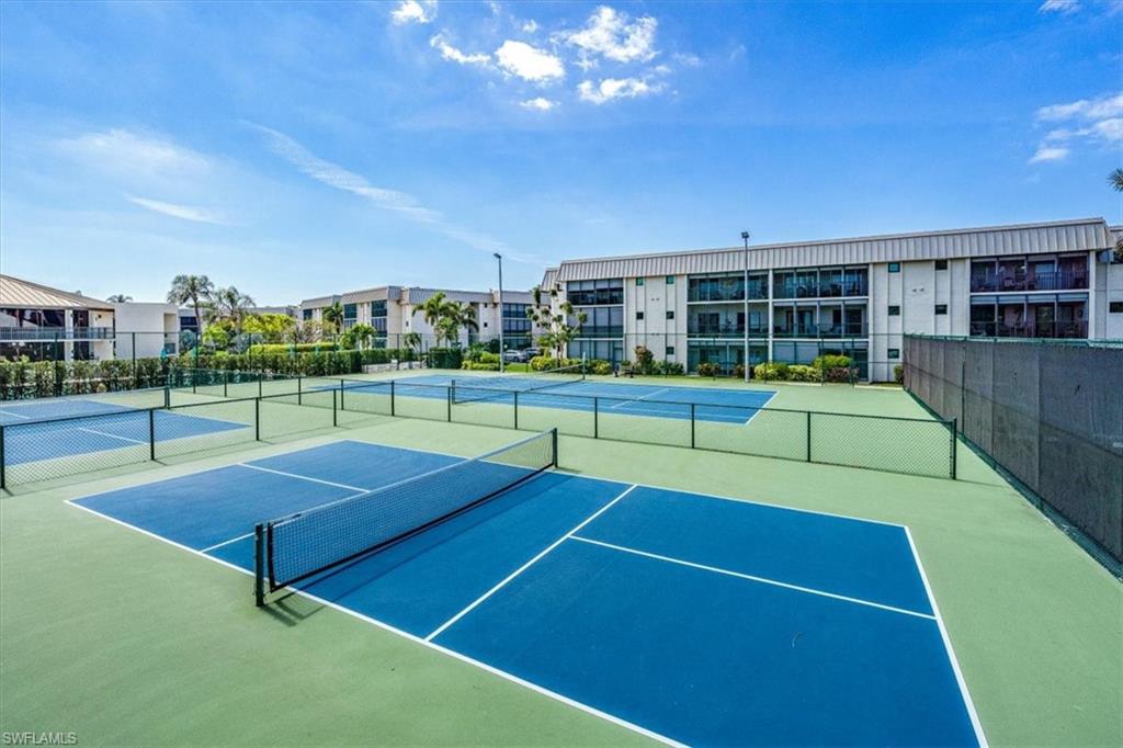788 Park Shore Drive, Unit E20 Naples, FL 34103 - Photo 30 of 37 a tennis court that has tennis net