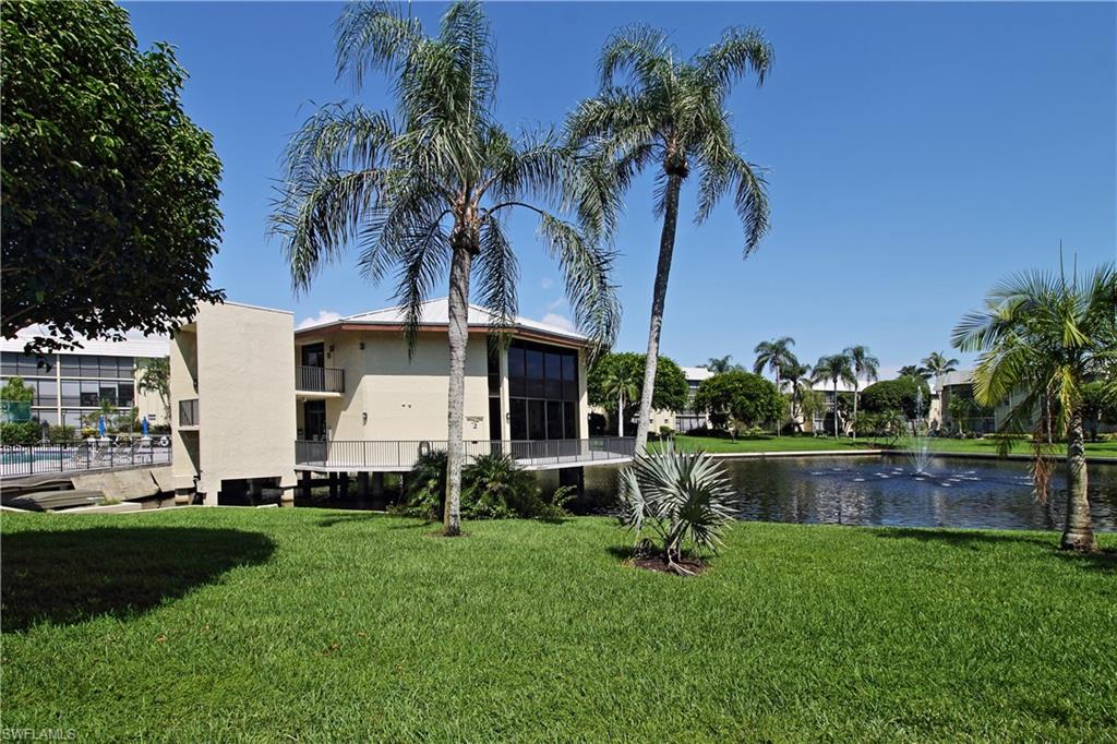 788 Park Shore Drive, Unit E20 Naples, FL 34103 - Photo 32 of 37 a front view of a house with garden and a yard