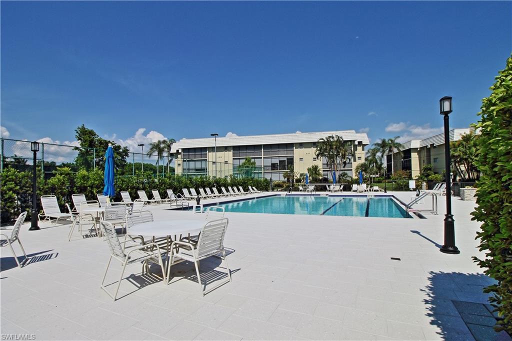 788 Park Shore Drive, Unit E20 Naples, FL 34103 - Photo 33 of 37 a swimming pool with outdoor seating and yard