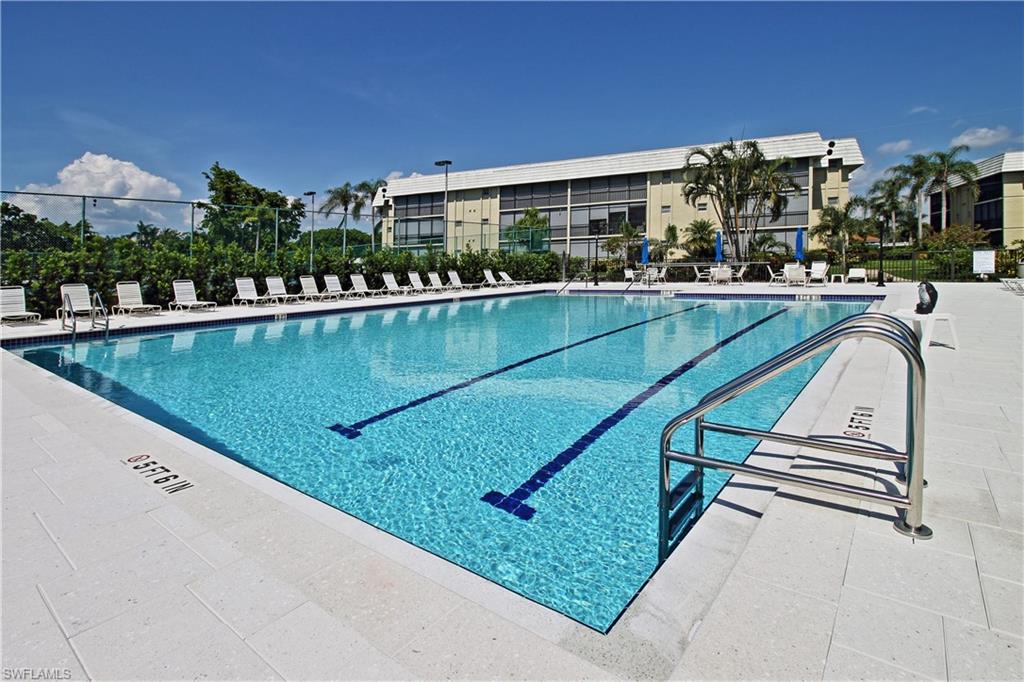788 Park Shore Drive, Unit E20 Naples, FL 34103 - Photo 34 of 37 a view of swimming pool with outdoor seating and city view