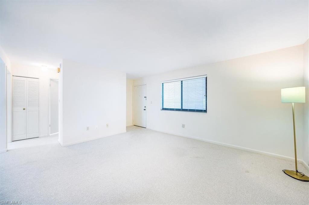 788 Park Shore Drive, Unit E20 Naples, FL 34103 - Photo 5 of 37 an empty room with windows