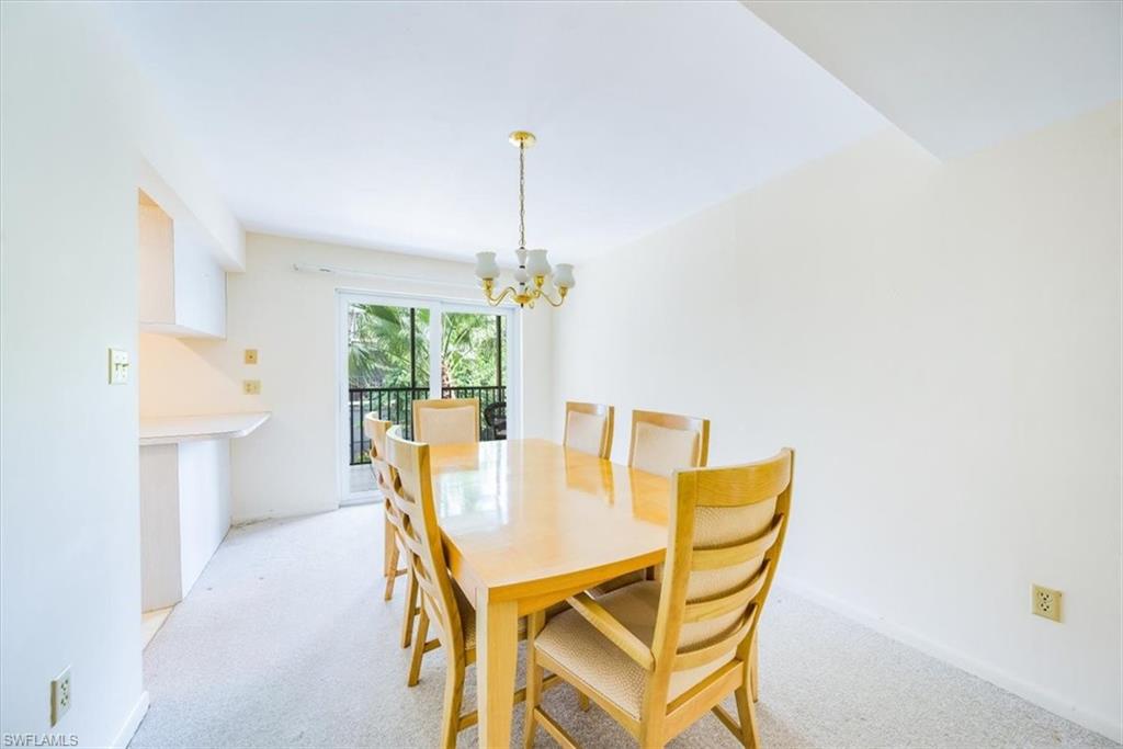 788 Park Shore Drive, Unit E20 Naples, FL 34103 - Photo 9 of 37 a view of a dining room with furniture and window