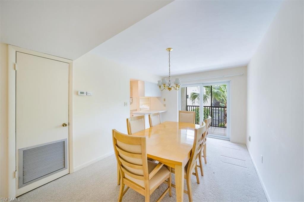 788 Park Shore Drive, Unit E20 Naples, FL 34103 - Photo 10 of 37 a view of a dining room with furniture