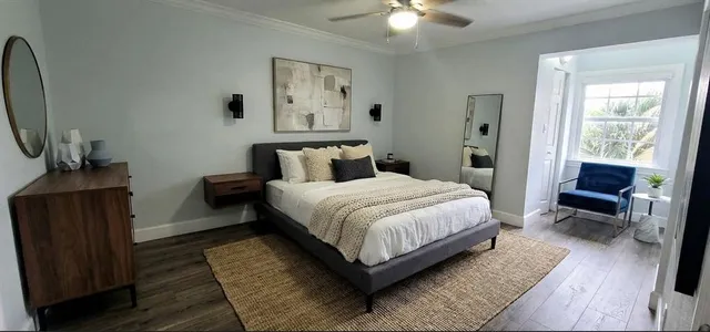a bedroom with a bed and a potted plant