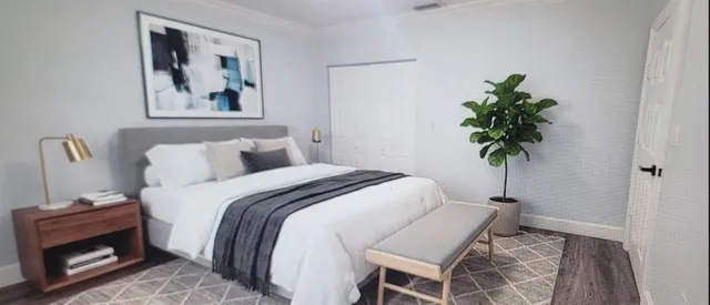 a bedroom with a bed and a couch