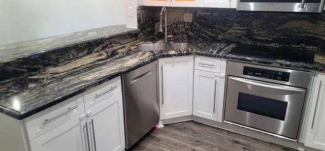 a stove top oven sitting inside of a kitchen