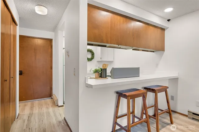 a view of hallway with table and chairs