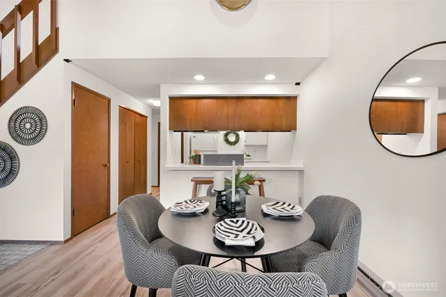 a view of a dining room with furniture and a mirror