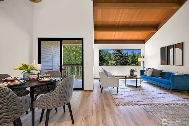 a dining room with furniture window and wooden floor