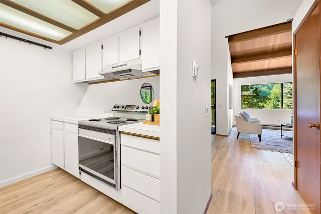 a kitchen with stainless steel appliances granite countertop a stove and a refrigerator