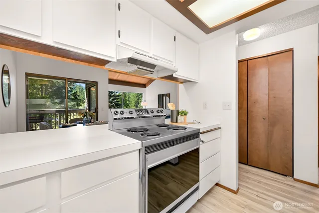 a kitchen with stainless steel appliances a stove and a refrigerator
