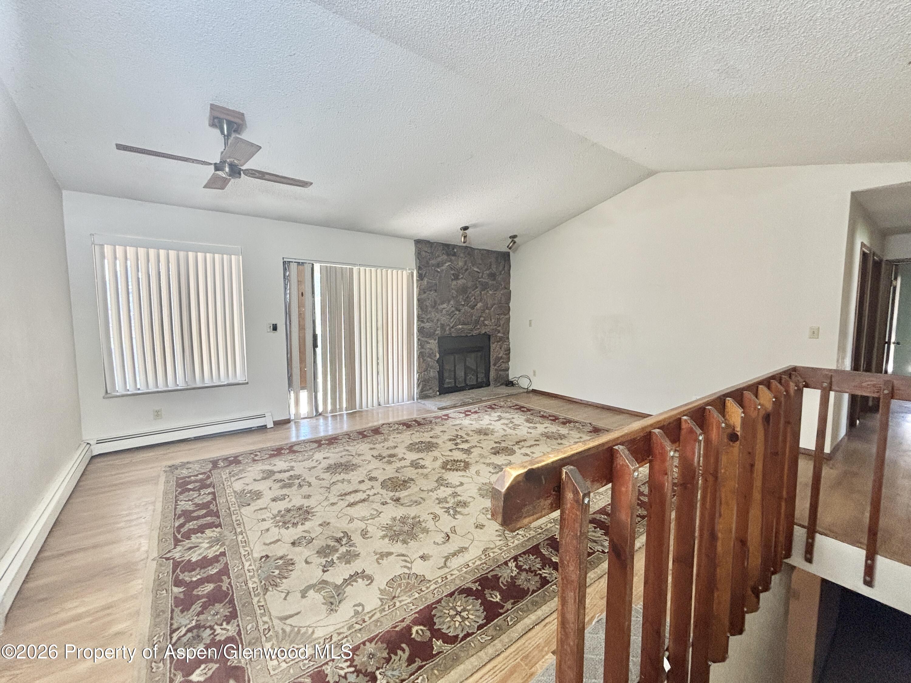 1623 West 7th Street Rifle, CO 81650 - Photo 5 of 21 wooden floor in an empty room with a window
