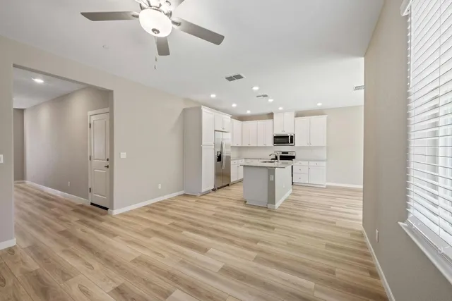 a view of kitchen with refrigerator stove microwave and cabinets