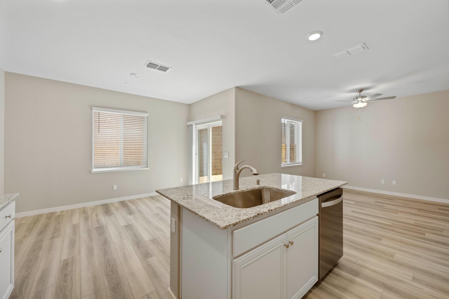 2578 Bog Street Lincoln, CA 95648 - Photo 6 of 19 a kitchen with a sink and chandelier