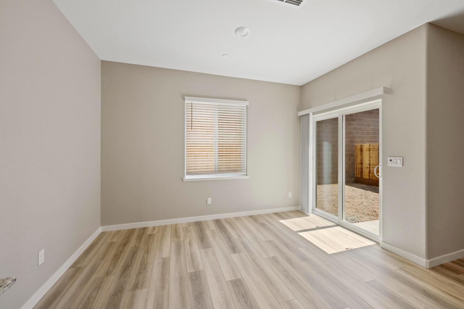 2578 Bog Street Lincoln, CA 95648 - Photo 7 of 19 an empty room with wooden floor and windows