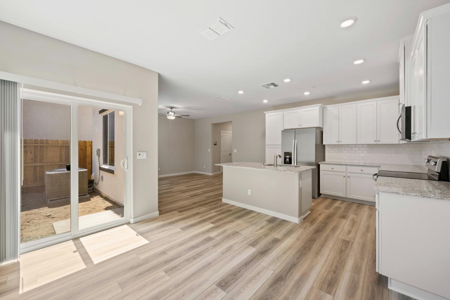 2578 Bog Street Lincoln, CA 95648 - Photo 8 of 19 a large kitchen with a lot of counter space and wooden floor