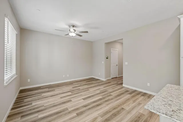 a view of room with window and ceiling fan