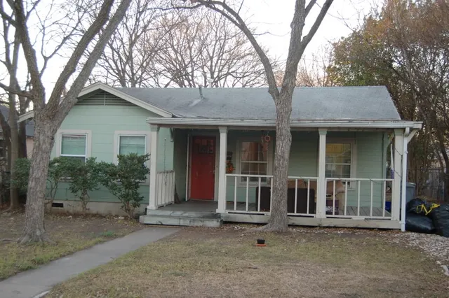 front view of a house with a large trees