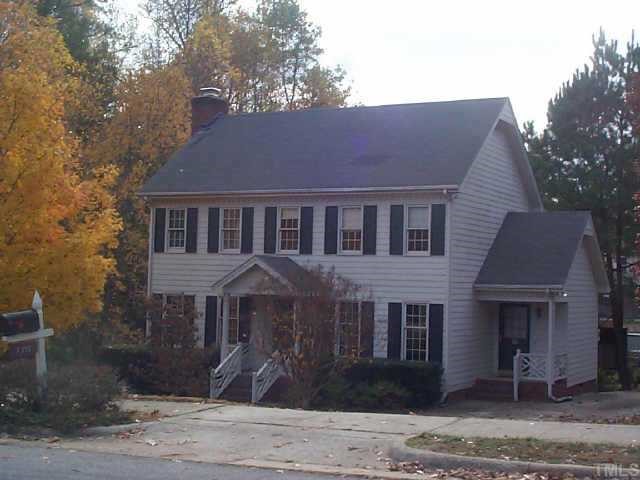 7313 Wilderness Road Raleigh, NC 27613 - Photo 1 of 1 a front view of a house with garden
