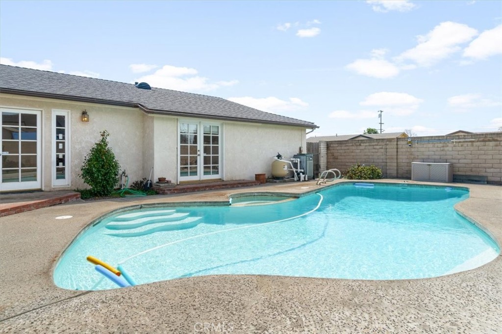 a view of a house with a swimming pool and a yard