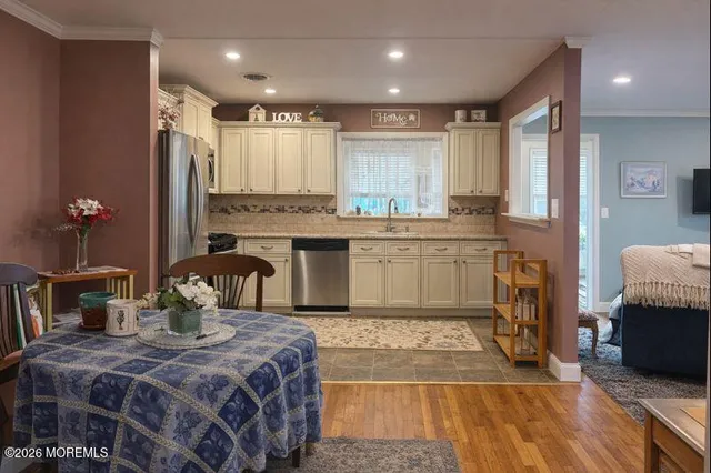 a large kitchen with kitchen island a sink stainless steel appliances and cabinets