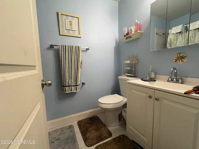 a bathroom with a sink toilet and a mirror