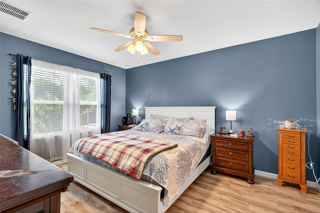 233 Periwinkle Drive Sebastian, FL 32958 - Photo 11 of 34 a bedroom with a bed and wooden floor