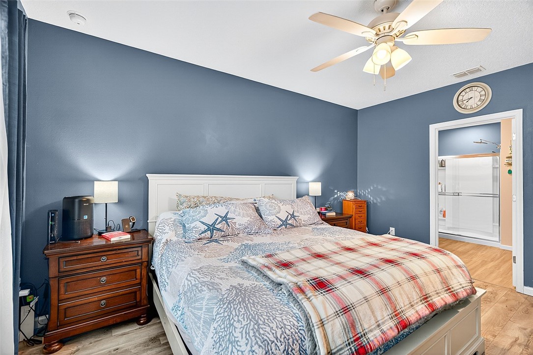 233 Periwinkle Drive Sebastian, FL 32958 - Photo 12 of 34 a bedroom with a large bed and a chandelier