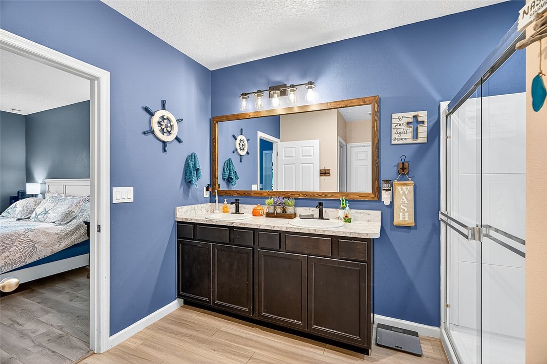 233 Periwinkle Drive Sebastian, FL 32958 - Photo 14 of 34 a en suite bathroom with a double vanity sink and mirror