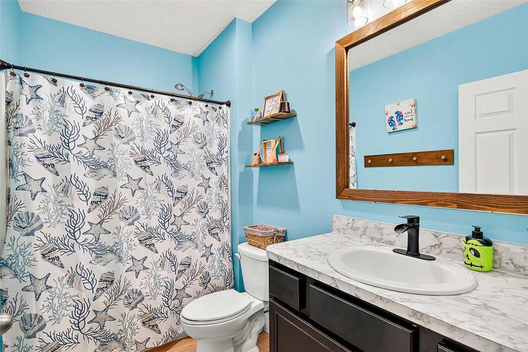 233 Periwinkle Drive Sebastian, FL 32958 - Photo 16 of 34 a bathroom with a granite countertop sink and a toilet
