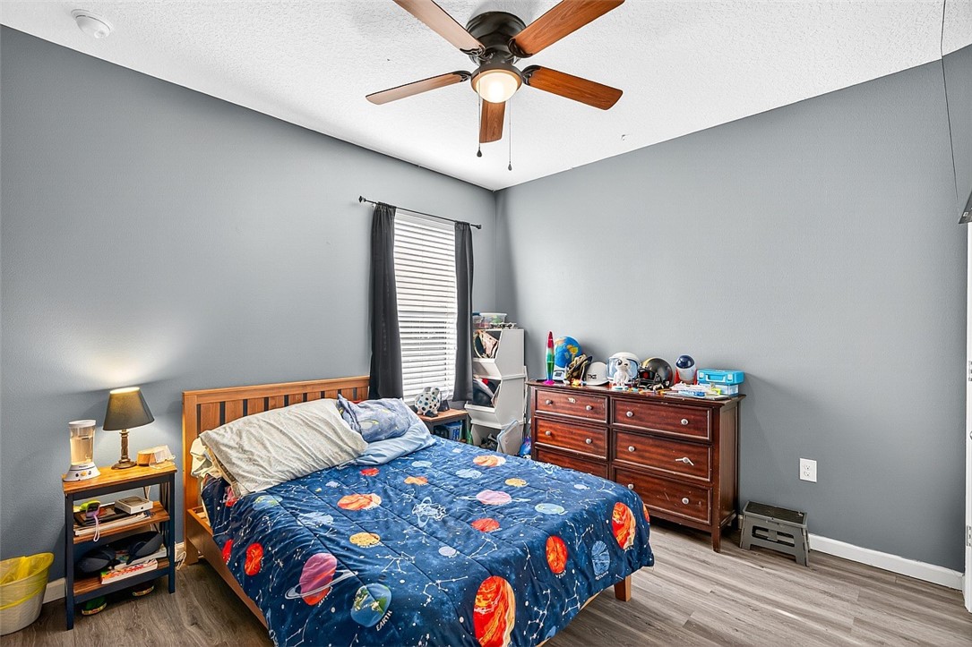 233 Periwinkle Drive Sebastian, FL 32958 - Photo 17 of 34 a bedroom with a bed and a chandelier