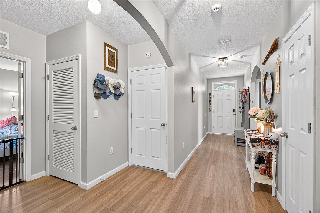 233 Periwinkle Drive Sebastian, FL 32958 - Photo 2 of 34 a view of a hallway with wooden floor and a living room