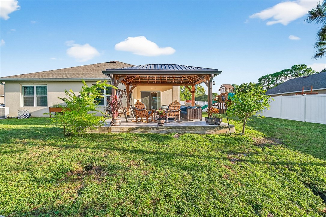 233 Periwinkle Drive Sebastian, FL 32958 - Photo 23 of 34 a view of a house with a backyard porch and sitting area