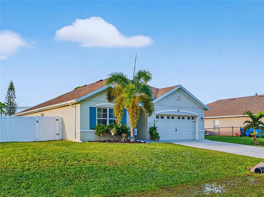 233 Periwinkle Drive Sebastian, FL 32958 - Photo 26 of 34 a front view of house with yard and garage